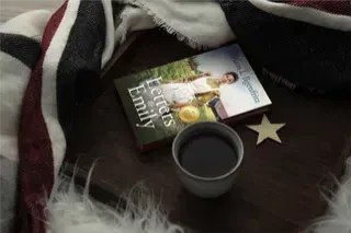 Letters to Emily with a warm cup of coffee and a cozy blanket